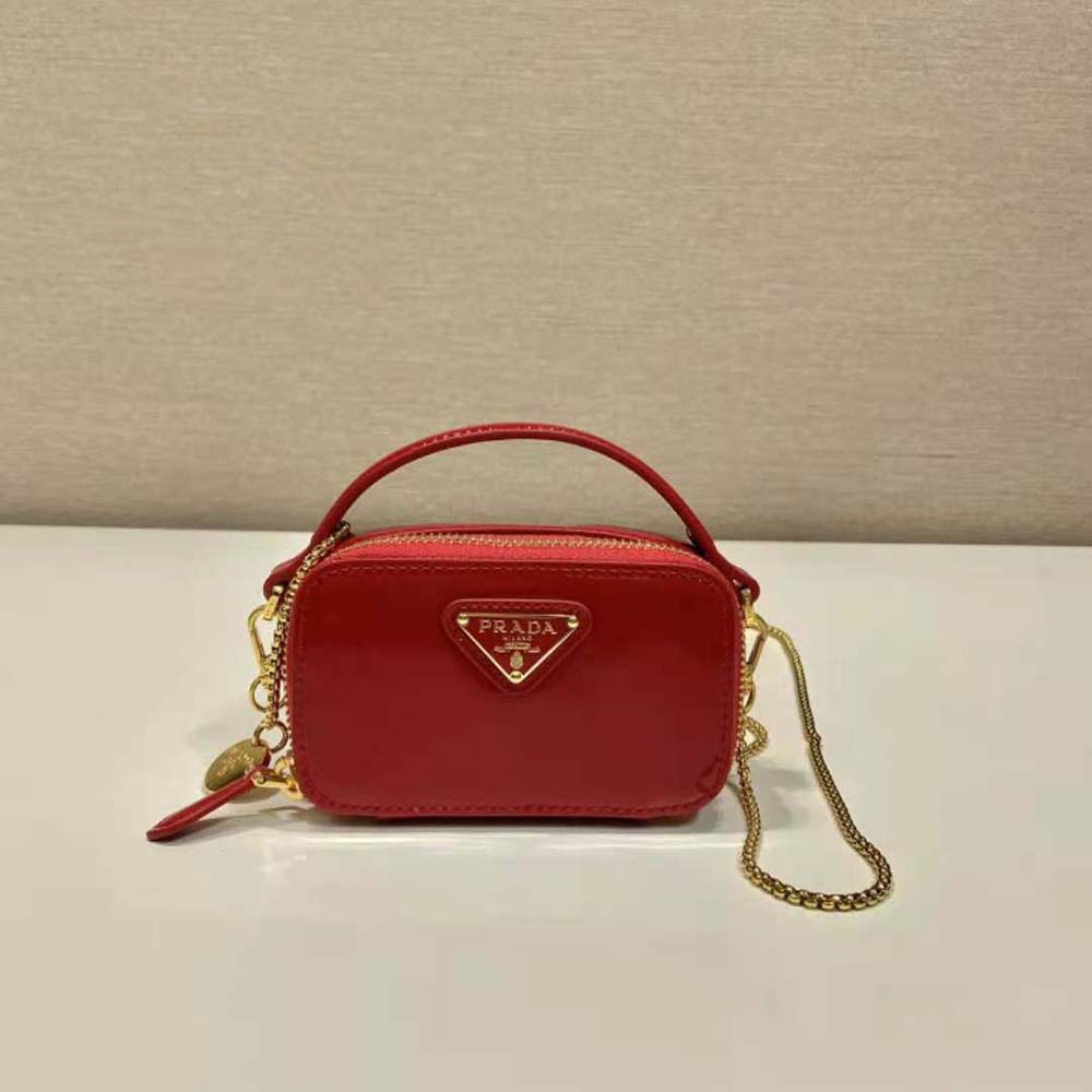 Close-up on glossy patent leather and zip closure of Prada mini-pouch