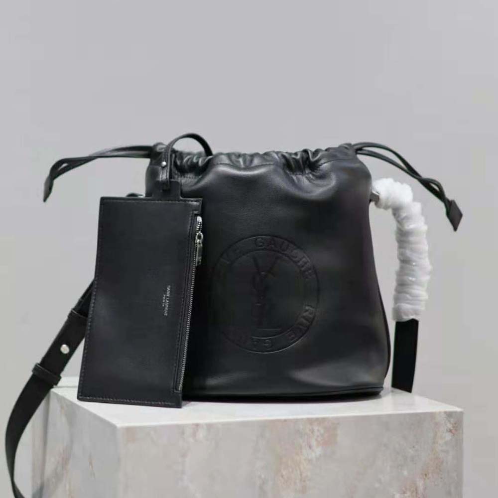 Close-up of silver YSL logo and laced detailing on bucket bag