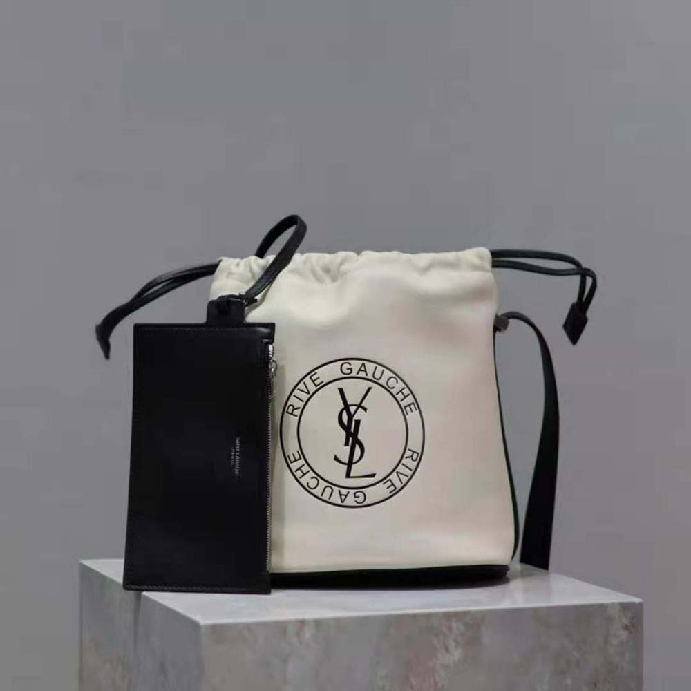 Close-up of gold-tone YSL logo hardware on bucket bag
