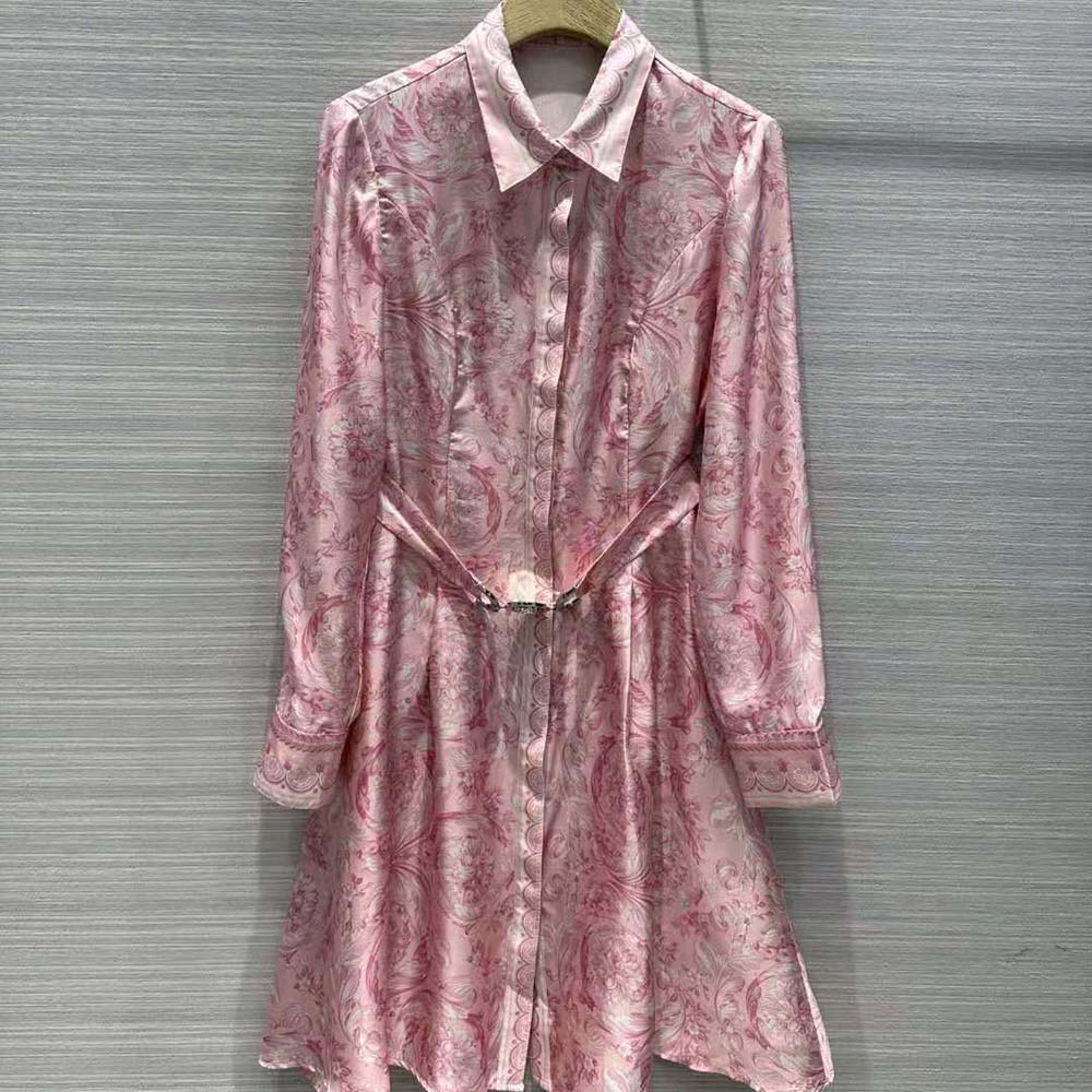 Close-up of Barocco print and gold Medusa button on dress