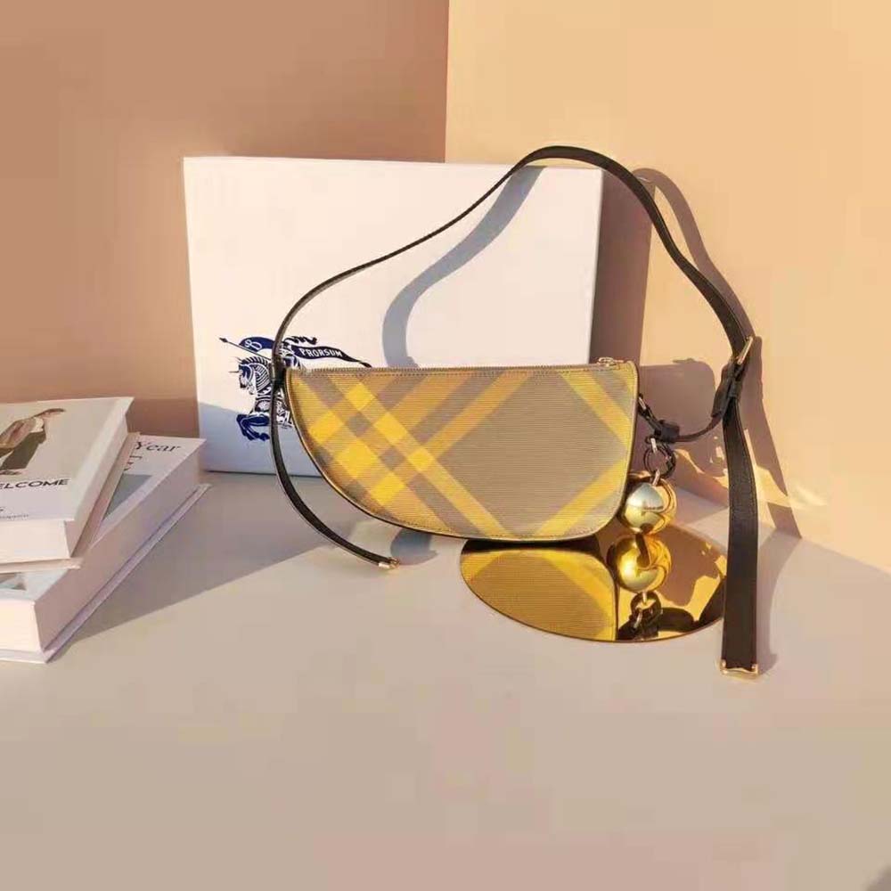 Close-up of gold-tone hardware and yellow leather texture on Burberry bag