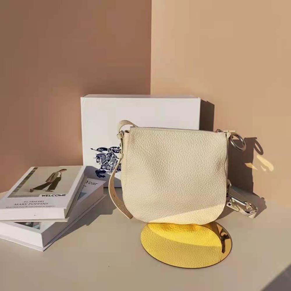 Side angle showing smooth leather texture on Burberry Women Small Knight Bag