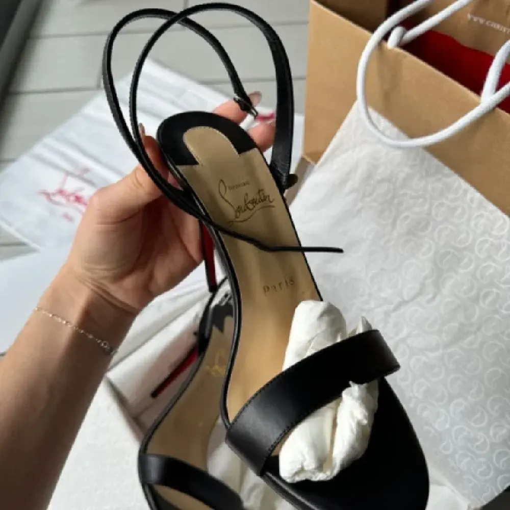 View of signature red sole on Christian Louboutin Loubigirl 100 mm sandals