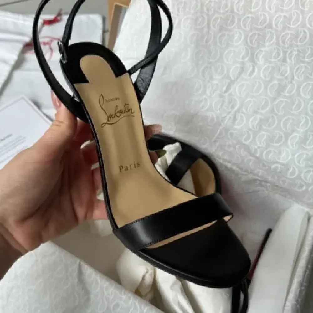 Close-up of black nappa leather and ankle strap on Loubigirl sandals
