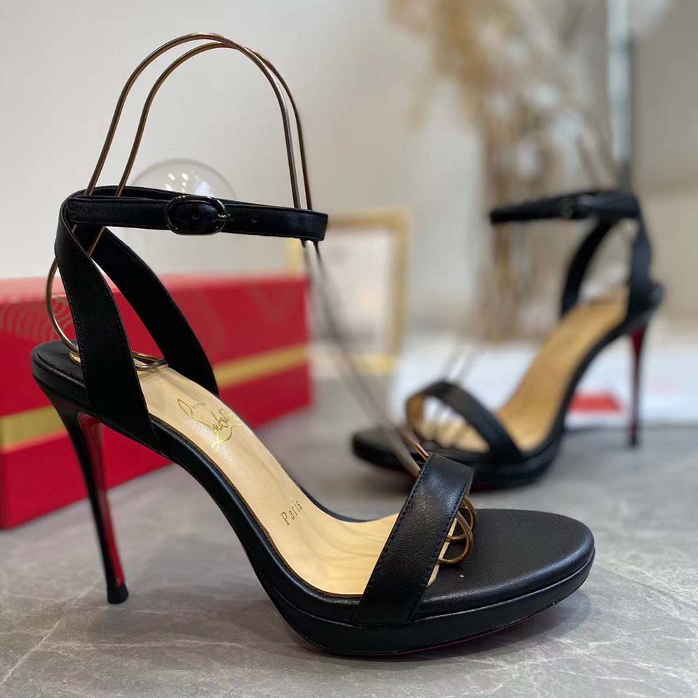Close-up of black nappa leather and buckle on Christian Louboutin Loubi Queen sandals