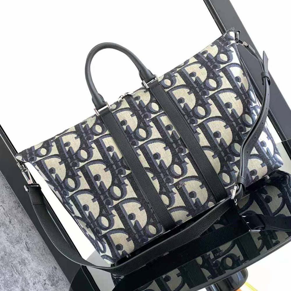 Side angle showing zip closure and gunmetal hardware on Dior Men Weekender 50 Bag