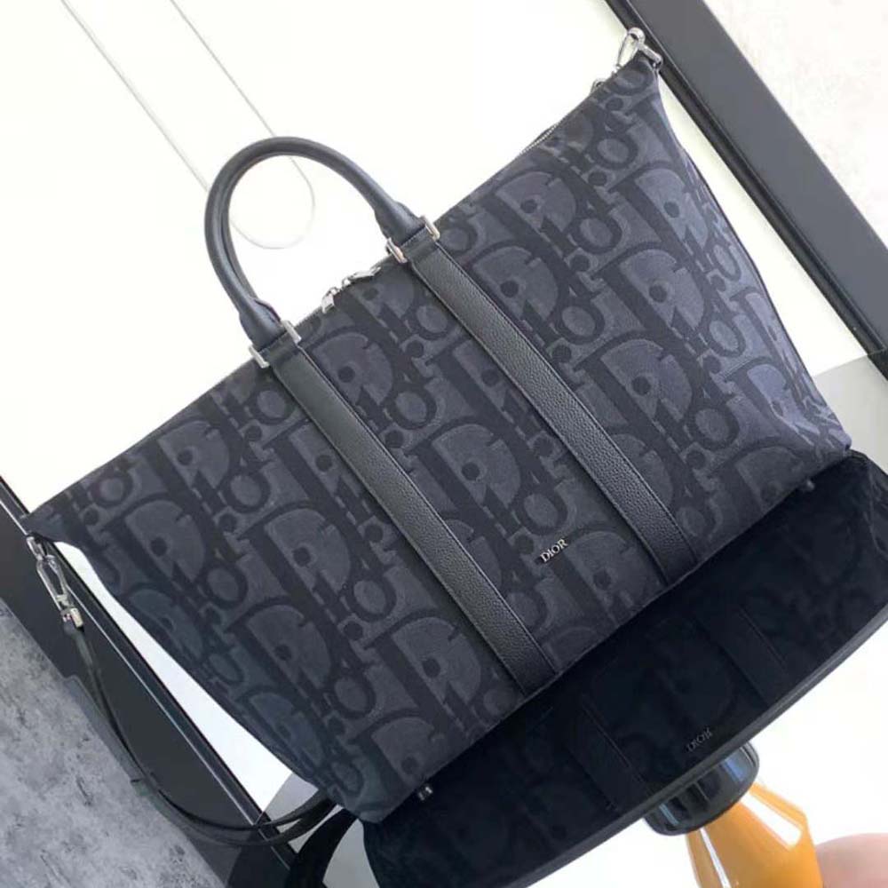 Close-up of black jacquard fabric and silver hardware on Dior Men Weekender 50 Bag