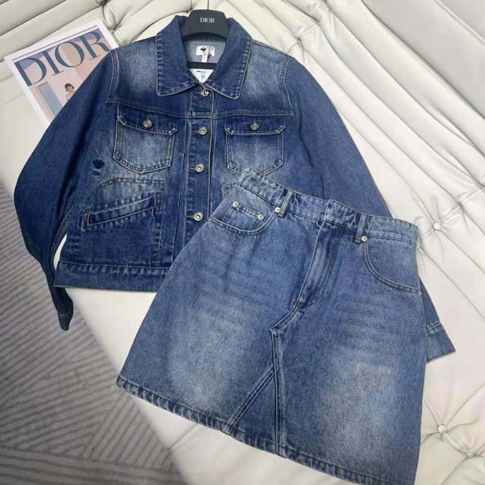 Close-up of Dior signature hardware on blue denim miniskirt