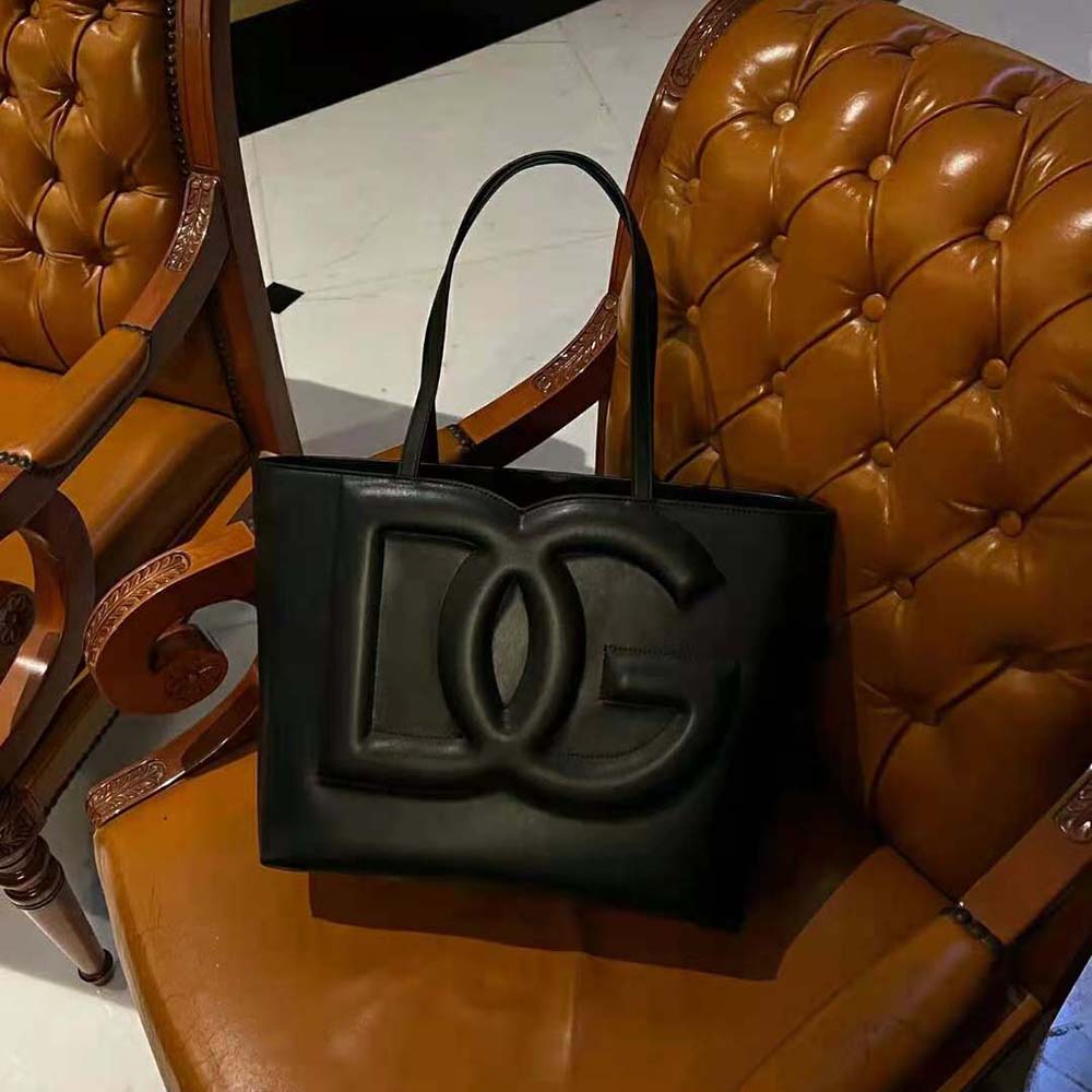 Close-up of silver DG logo hardware on black calfskin shopper bag