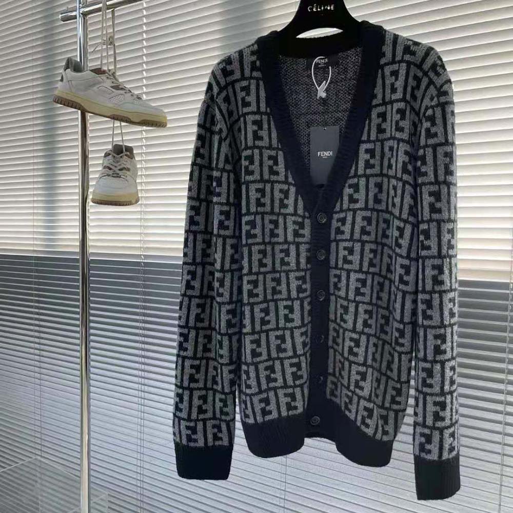 Close-up detail of Fendi logo zipper on black cashmere cardigan