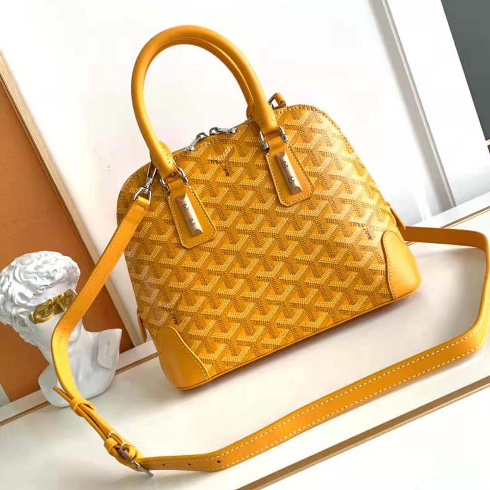 Side angle showing slim profile of Goyard Women Vendôme Mini Bag-Yellow