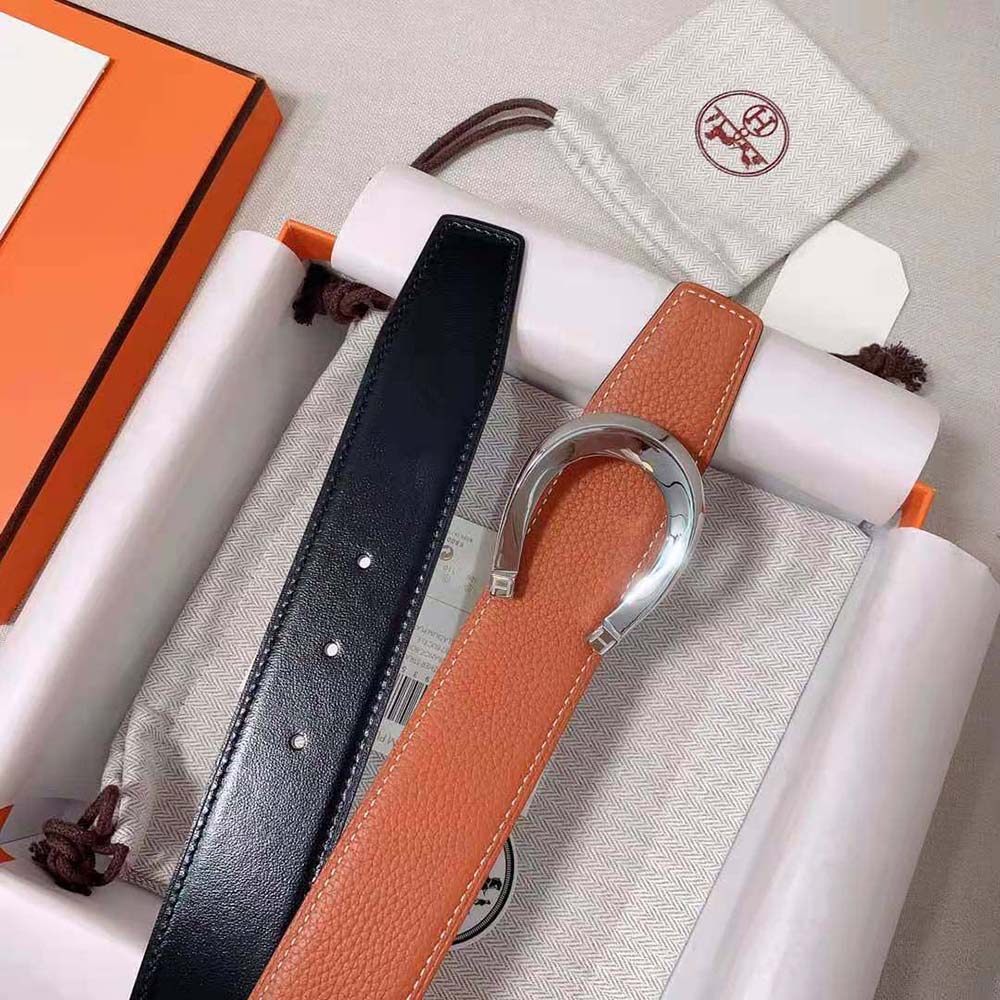 Side angle showcasing reversible orange leather strap on Hermes Men Luck Belt
