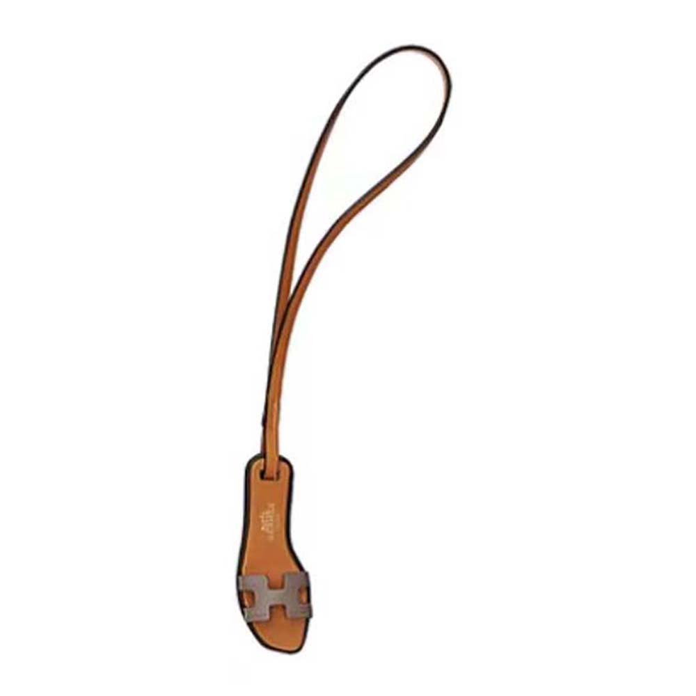 Hermes Oran Nano Charm-Brown front view showing signature cutout