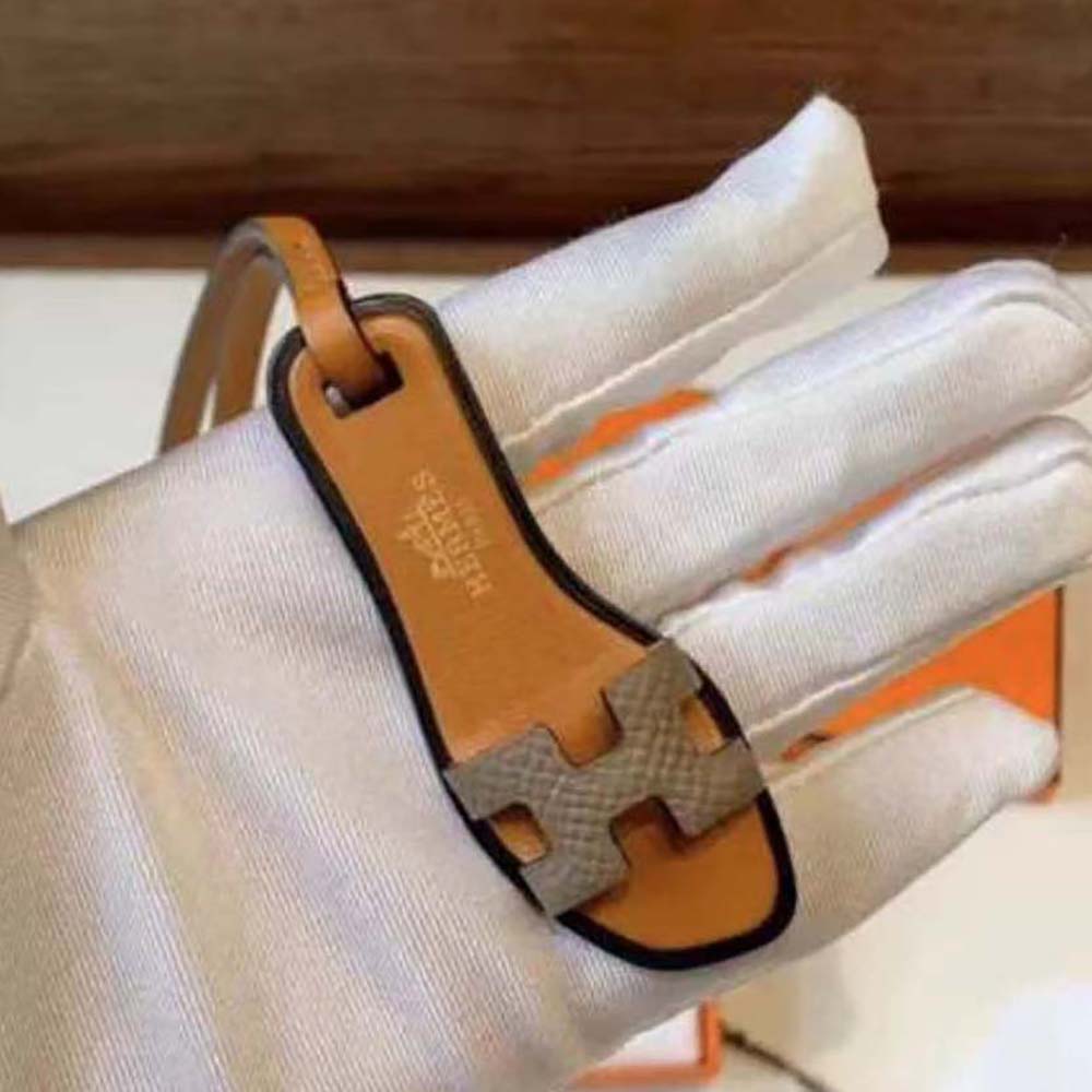 Close-up of Hermes Oran Nano Charm-Brown gold-tone clasp detail