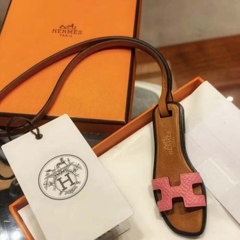 Hermes Oran Nano Charm-Pink hanging on a leather tote handle