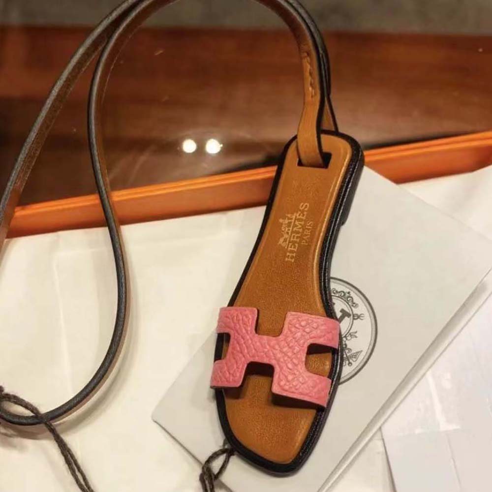 Close-up detail of pink calfskin and H cutout on Hermes charm