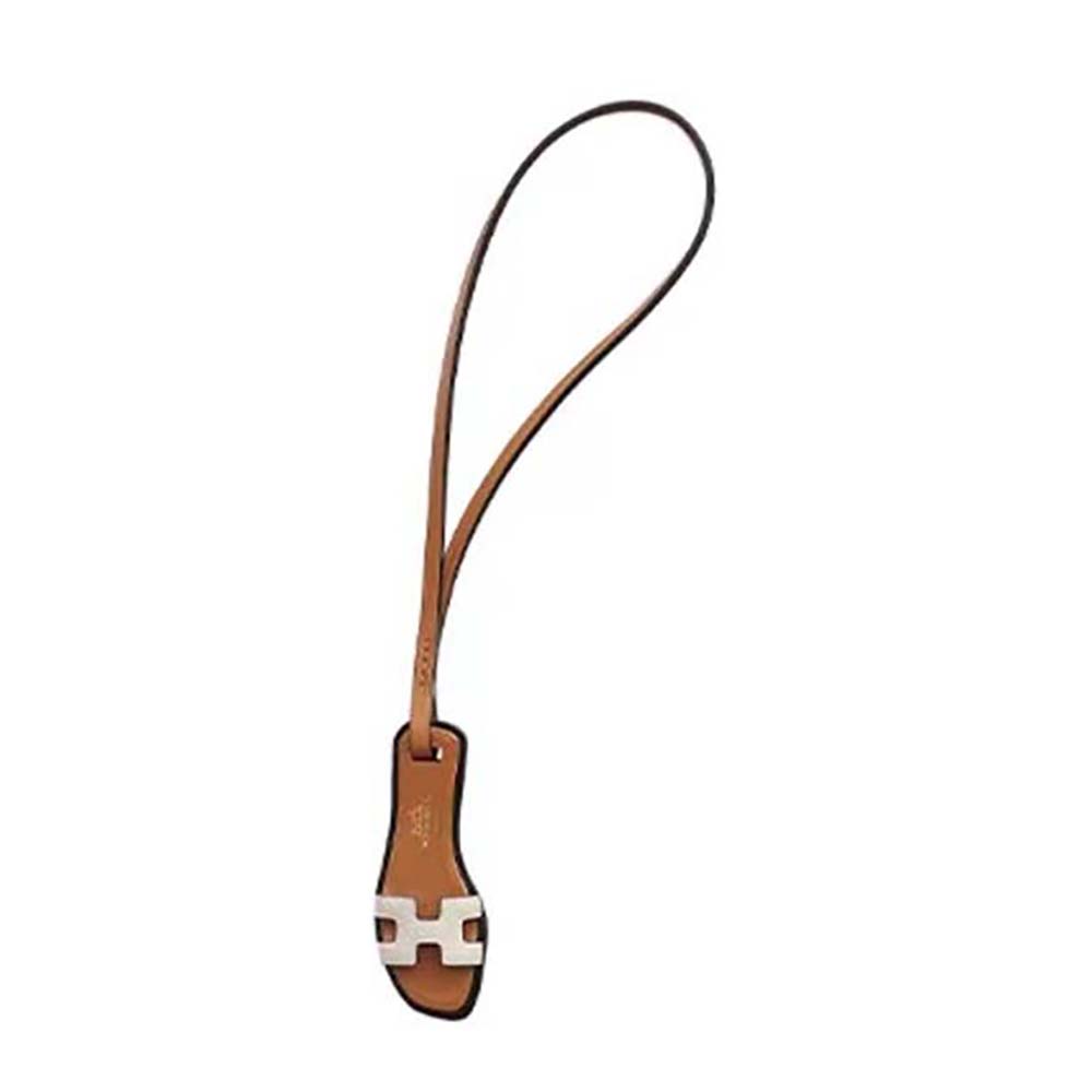 Close-up of Hermes Oran Nano Charm-White showing leather and H detail
