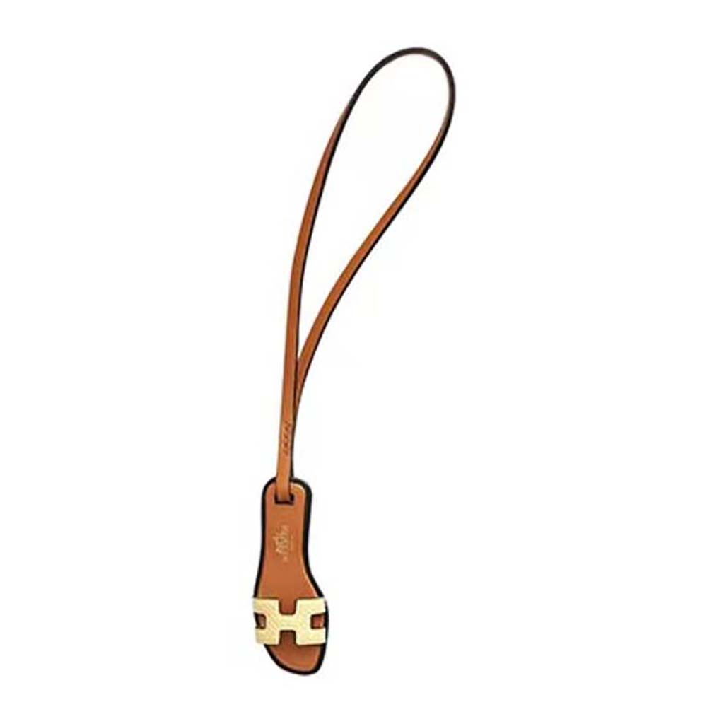 Close-up of Hermes Oran Nano Charm-Yellow leather texture and gold link