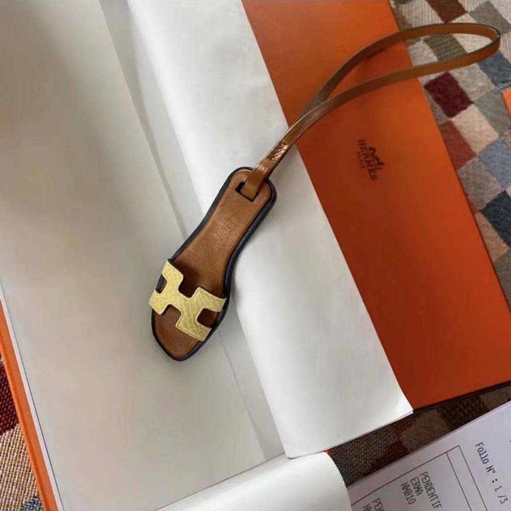 Hermes Oran Nano Charm-Yellow attached to yellow leather bag handle