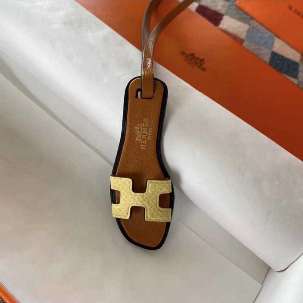 Side angle of Hermes Oran Nano Charm-Yellow showing compact silhouette