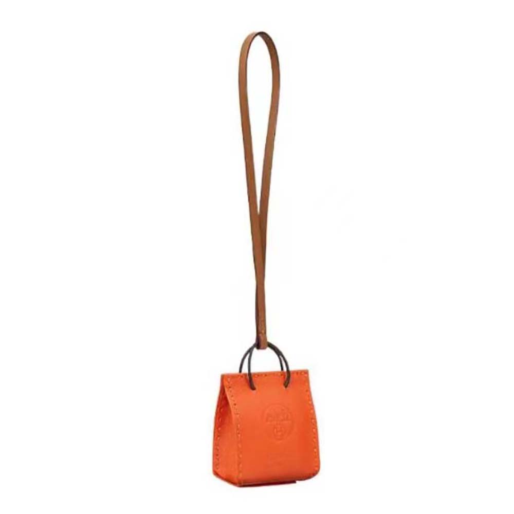 Close-up of Hermes Orange Bag Charm vibrant orange leather and silver hardware