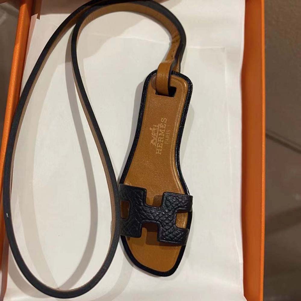 Close-up of black calfskin leather on Hermes Oran Nano Charm-Black