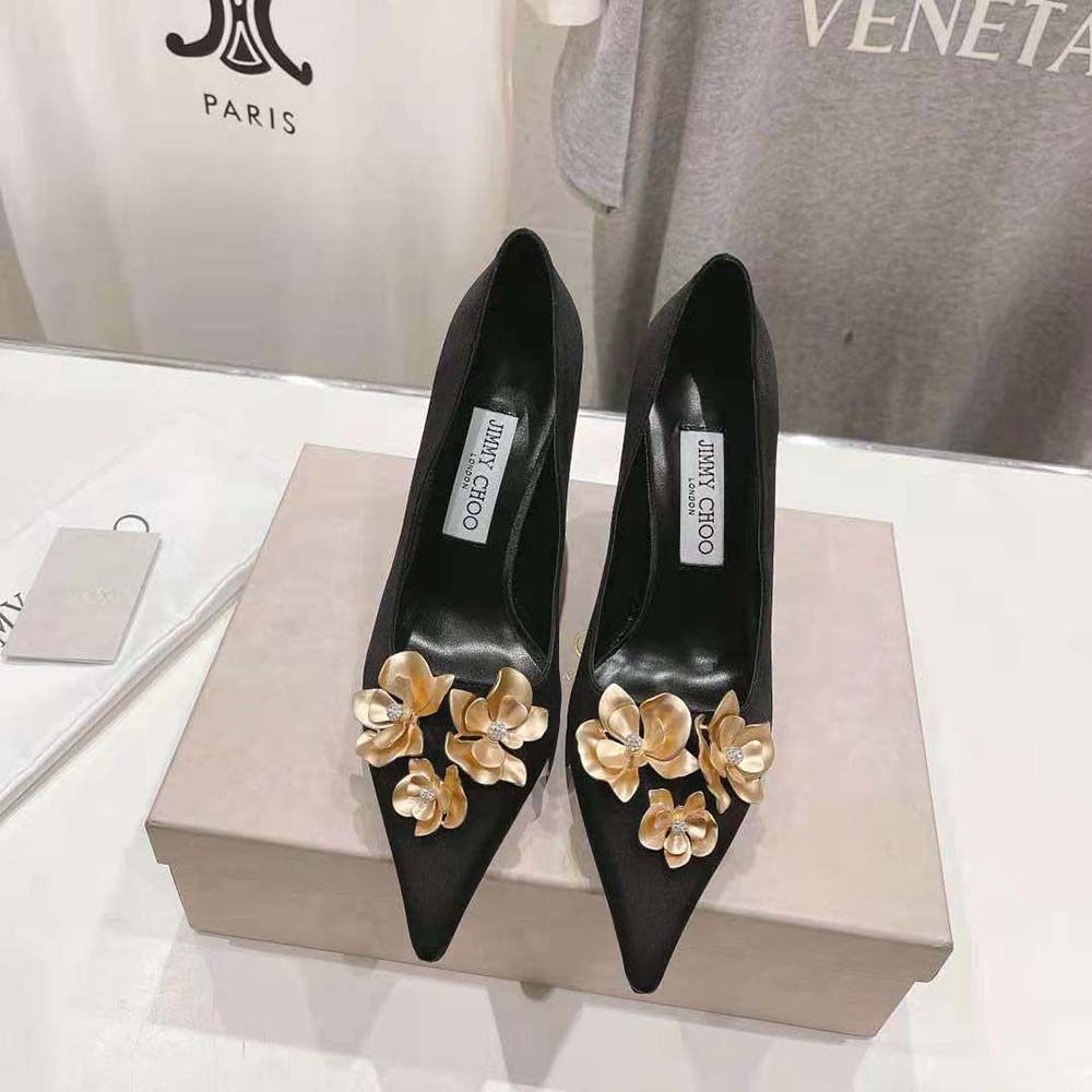 Close-up of floral embellishments on Jimmy Choo Ixia 95 black satin pumps