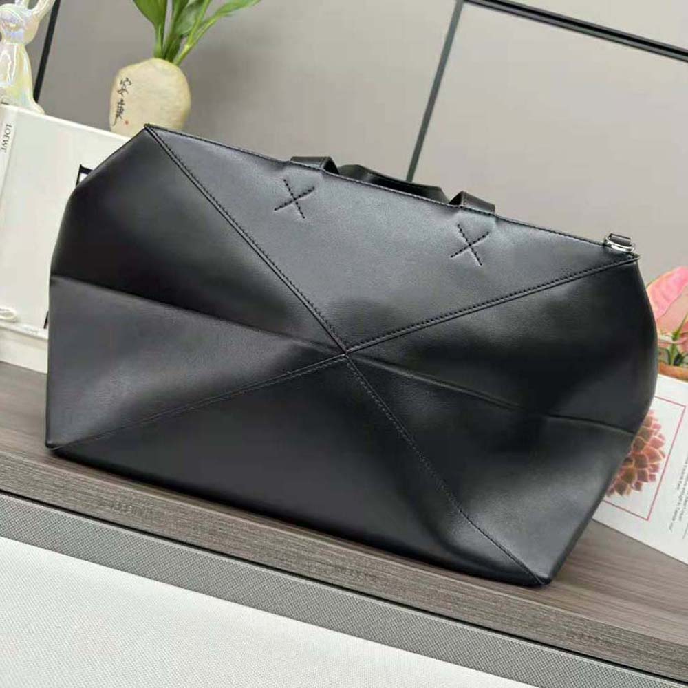 Side profile showing leather handles and zip closure on Loewe Men XL Tote