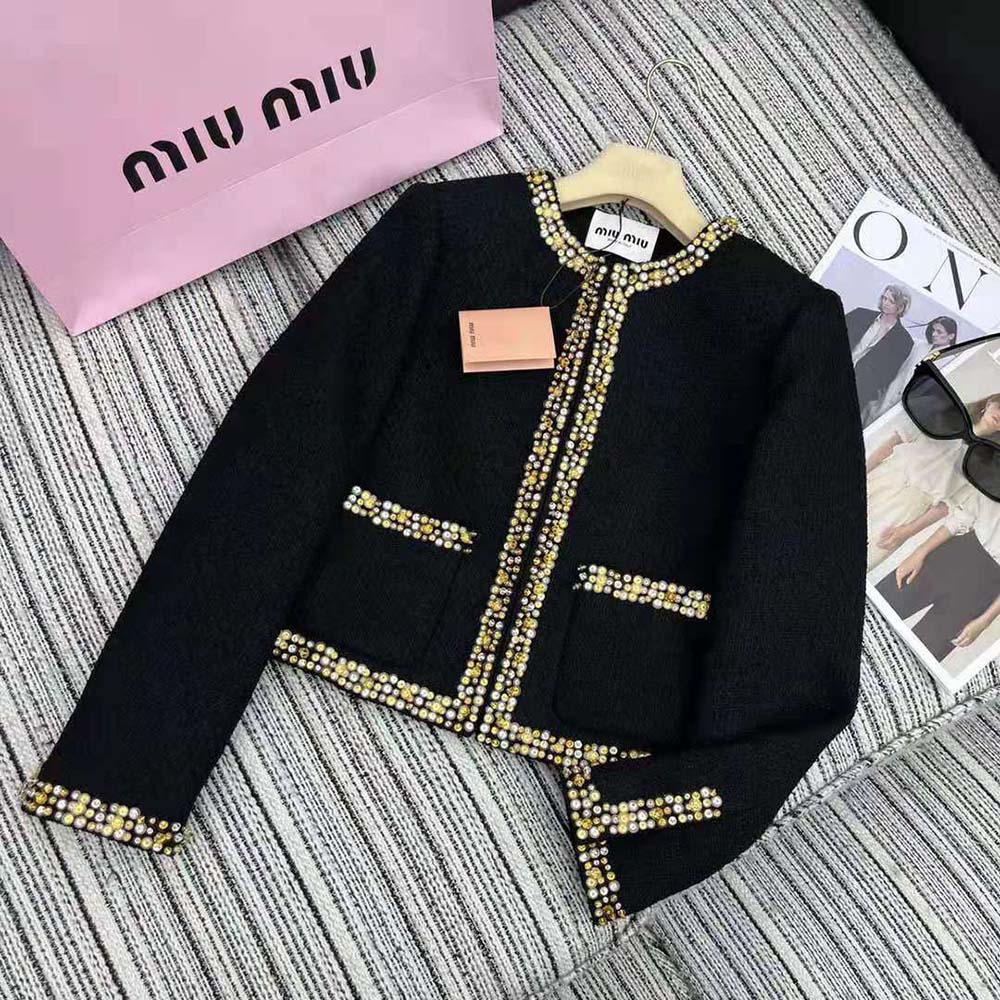 Close-up of tweed fabric and branded buttons on the Miu Miu jacket