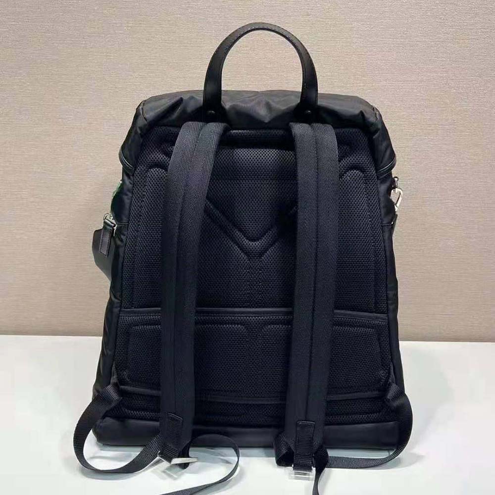 Side angle showing strap and zip closure details of Prada backpack