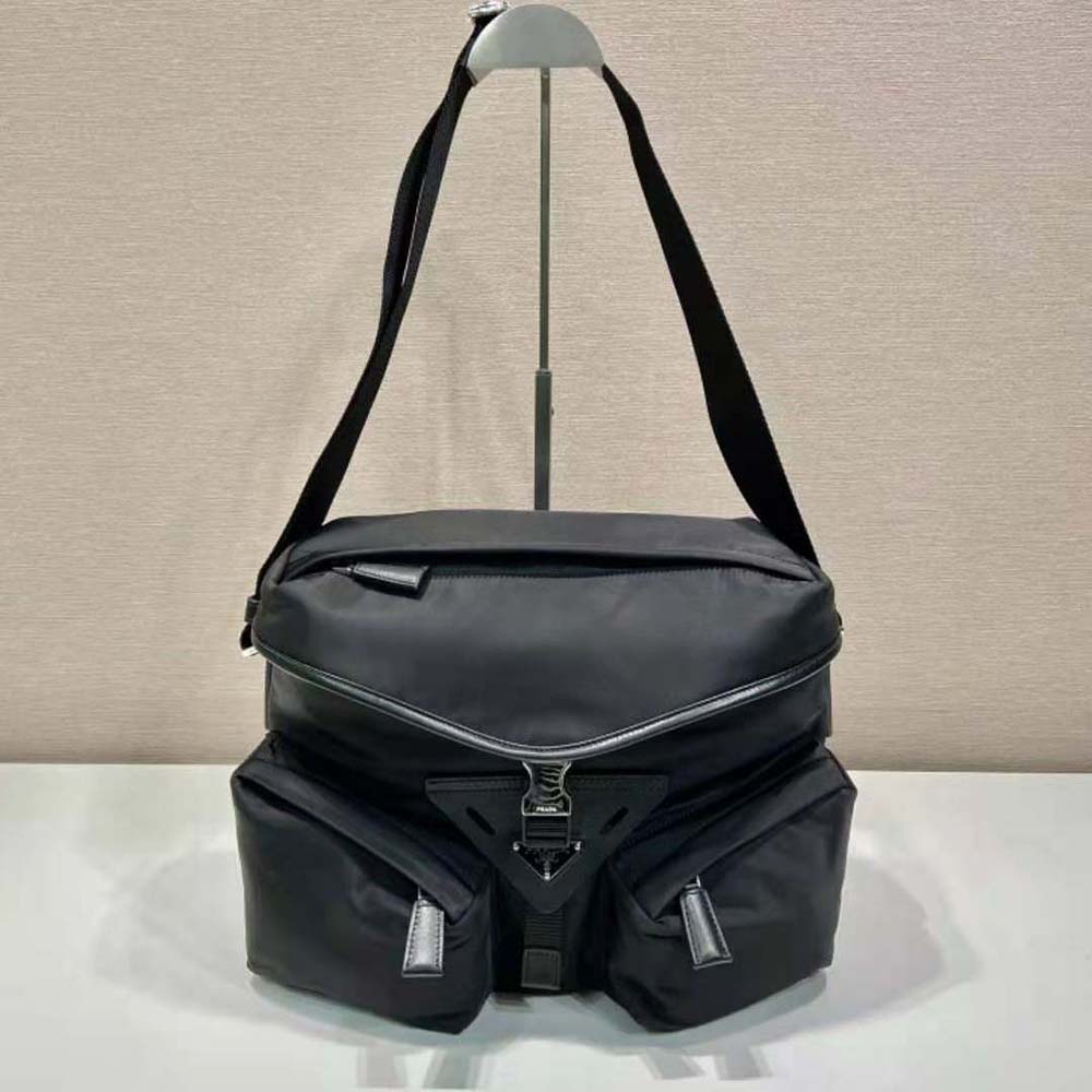Close-up of Prada triangular logo on black shoulder bag