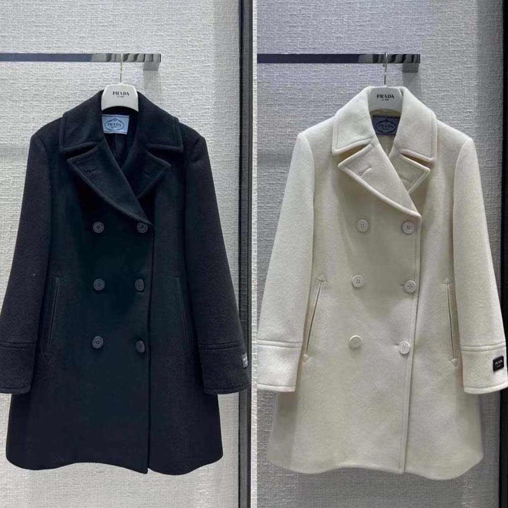 Close-up of signature Prada logo buttons on black peacoat