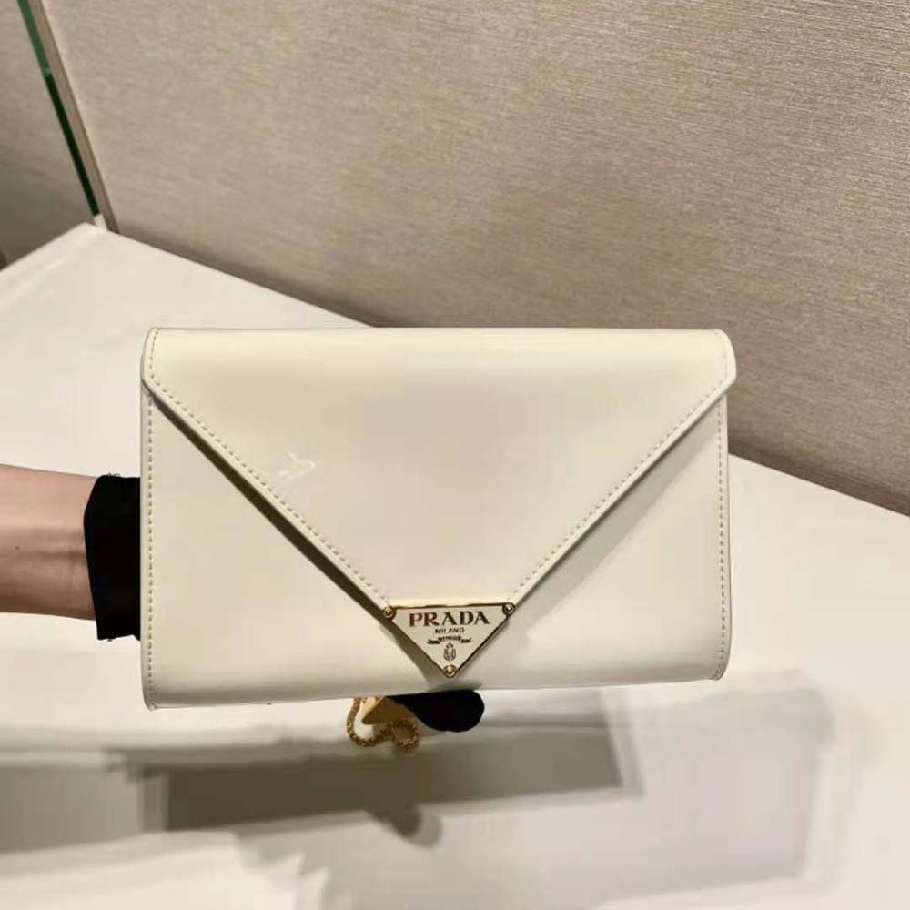 Close-up detail of white patent leather and Prada hardware