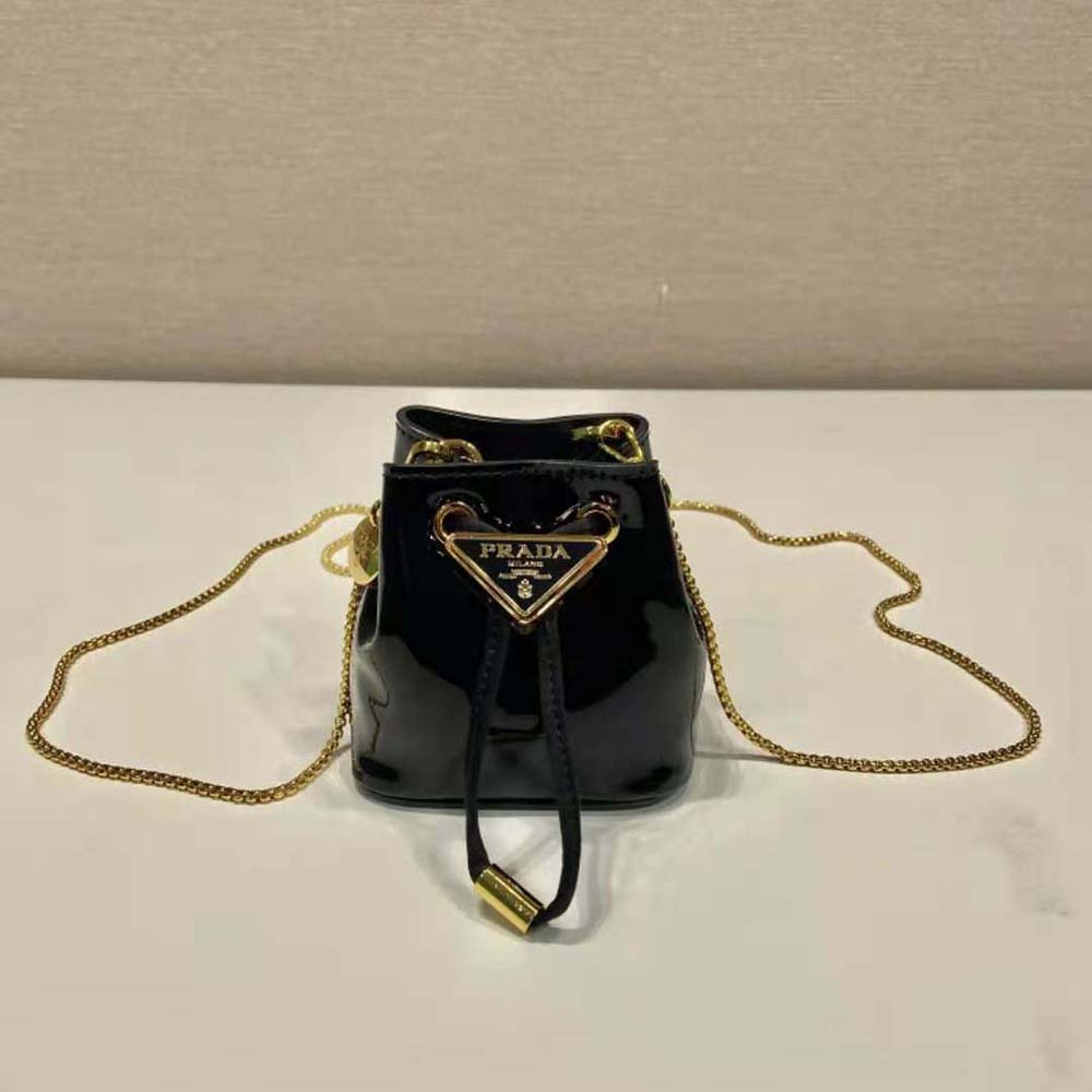 Close-up of glossy patent leather and silver hardware on Prada mini-pouch