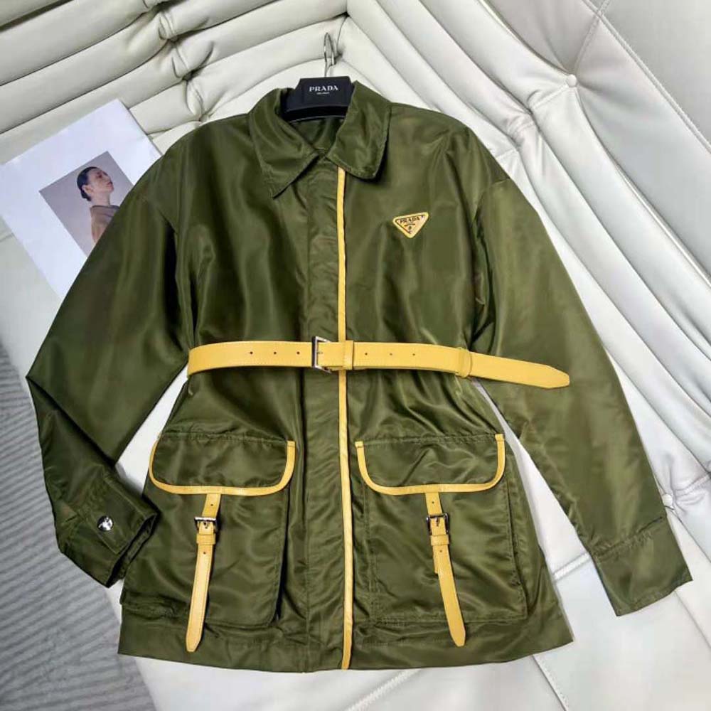 Close-up of Prada signature plaque on green Re-Nylon jacket