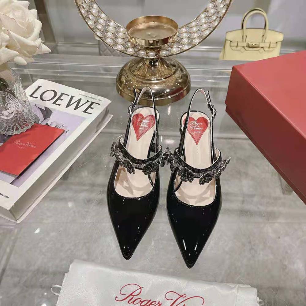 Close-up of signature flower buckle on Roger Vivier Virgule Flower Slingback Pumps