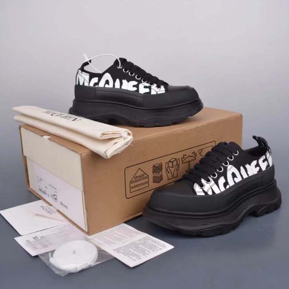 Close-up on black leather and graffiti tread sole of Alexander Mcqueen sneaker