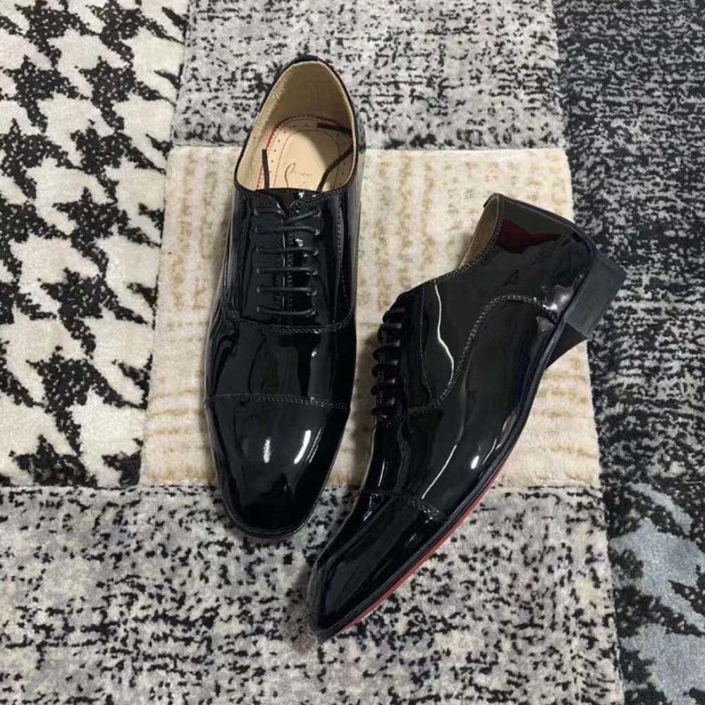 Close-up on iconic red sole of Christian Louboutin Men Greggo Lace-up Shoes