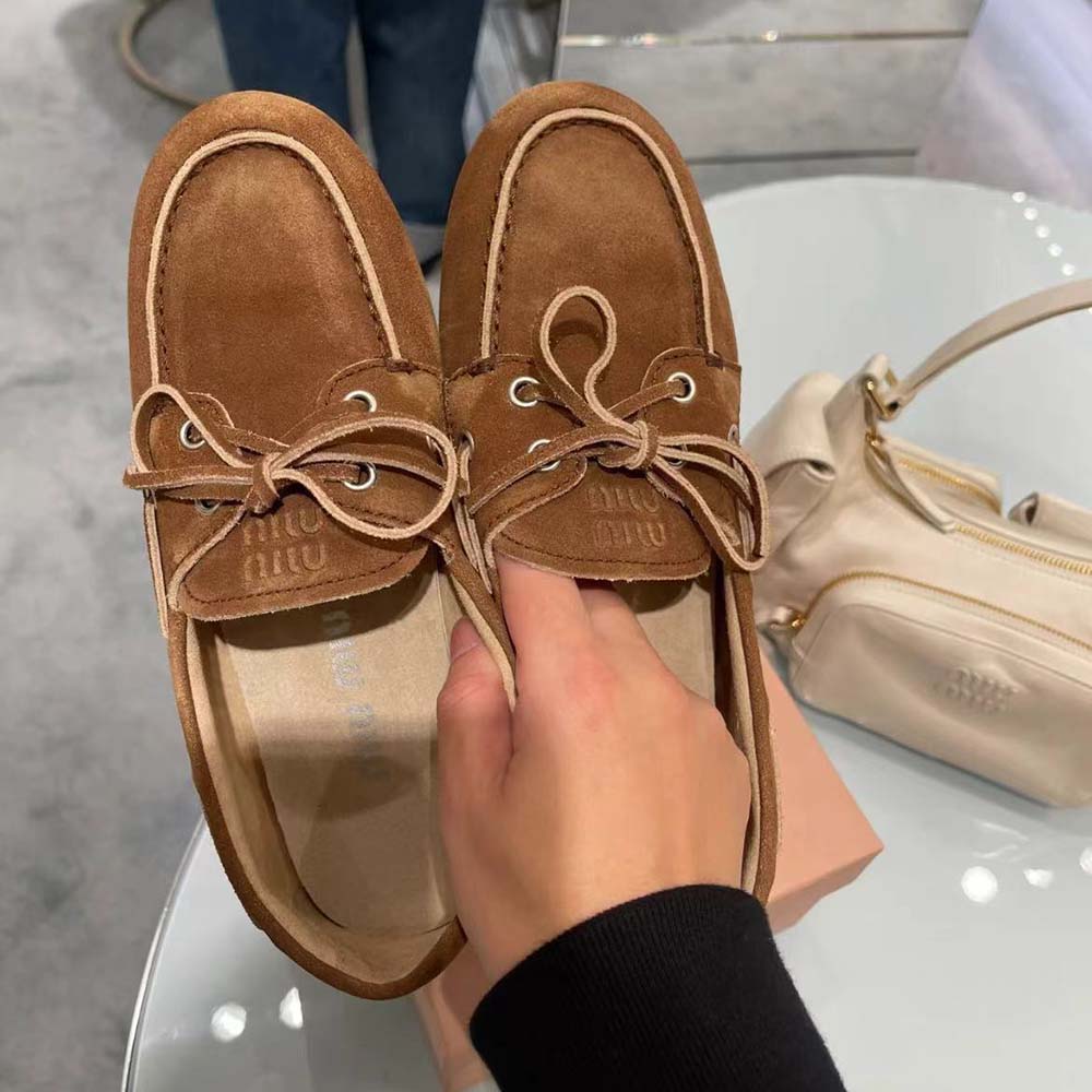 Top-down angle highlighting signature stitching on Miu Miu Women Brown Loafers