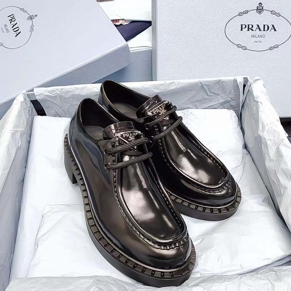 Close-up of brushed black leather and lace-up detail on Prada shoes