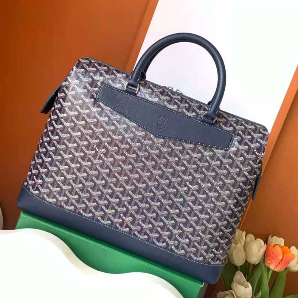 Close-up of navy coated canvas and silver hardware on Goyard document case
