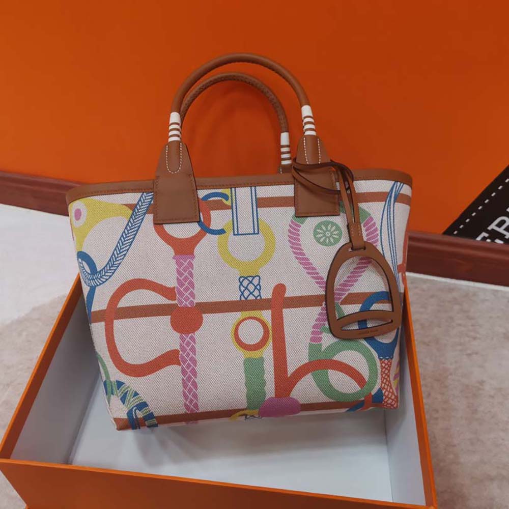 Close-up of silver-tone hardware and leather stitching on Hermes tote