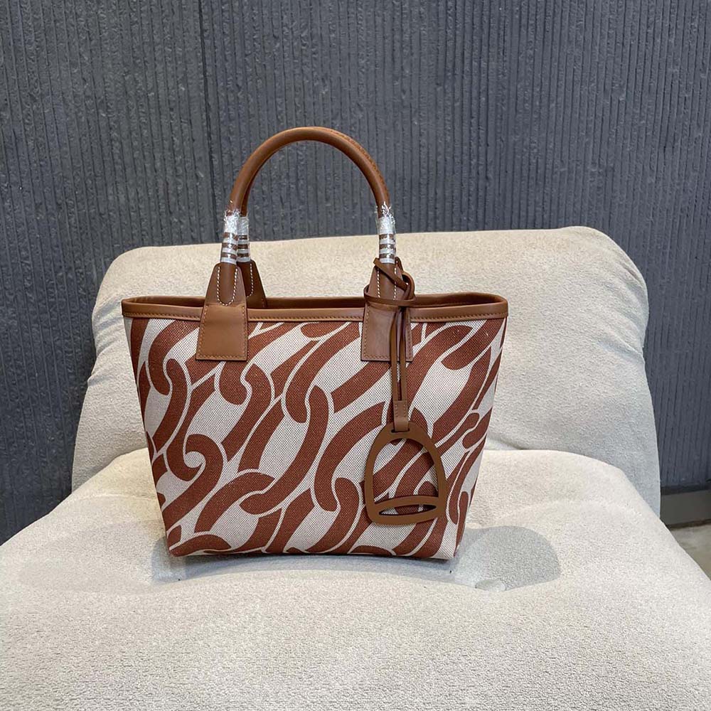 Close-up of gold-tone hardware and ecru stitching on Hermes Steeple tote