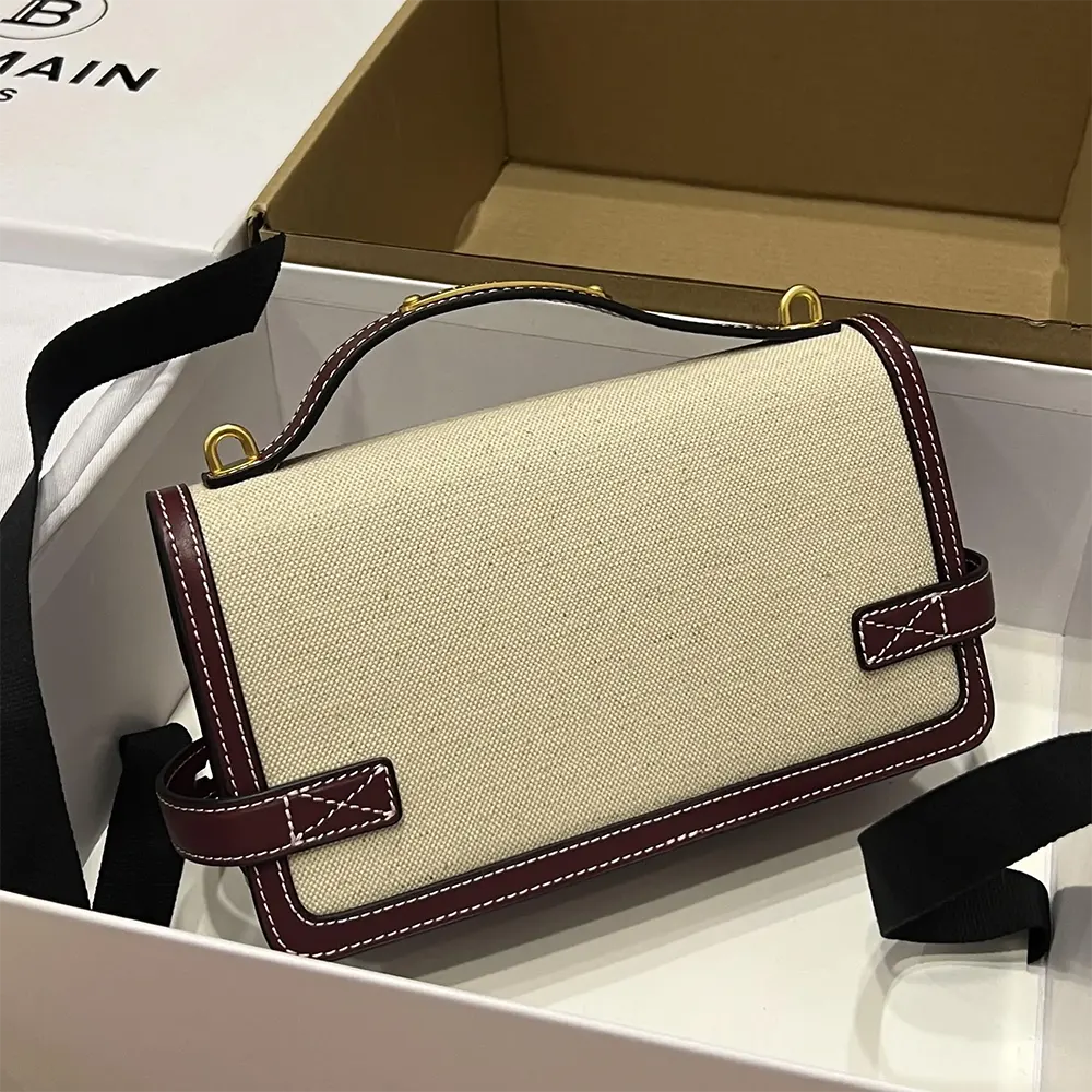 Side profile showing leather trim on Balmain Women B Buzz 24 Canvas and Leather Bag