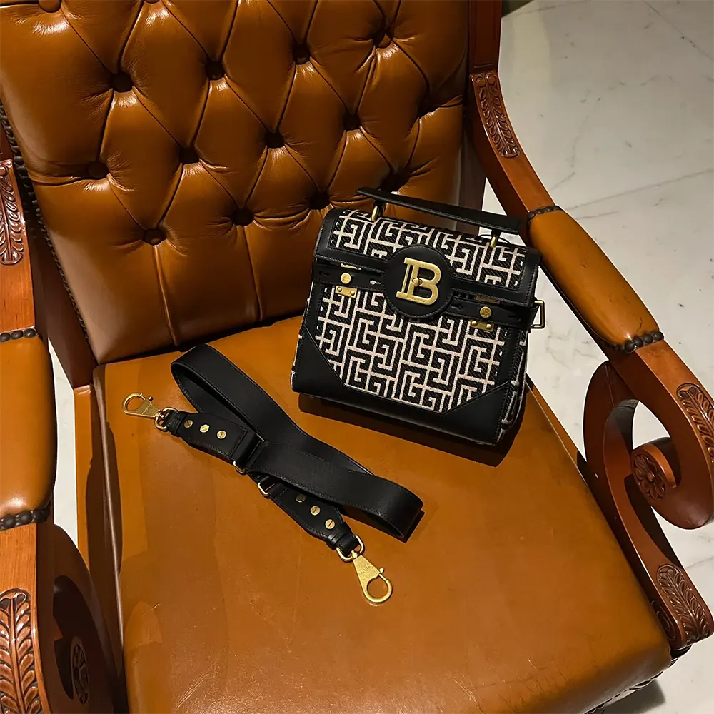 Close-up of gold-tone Balmain B-logo hardware on B-Buzz Bag