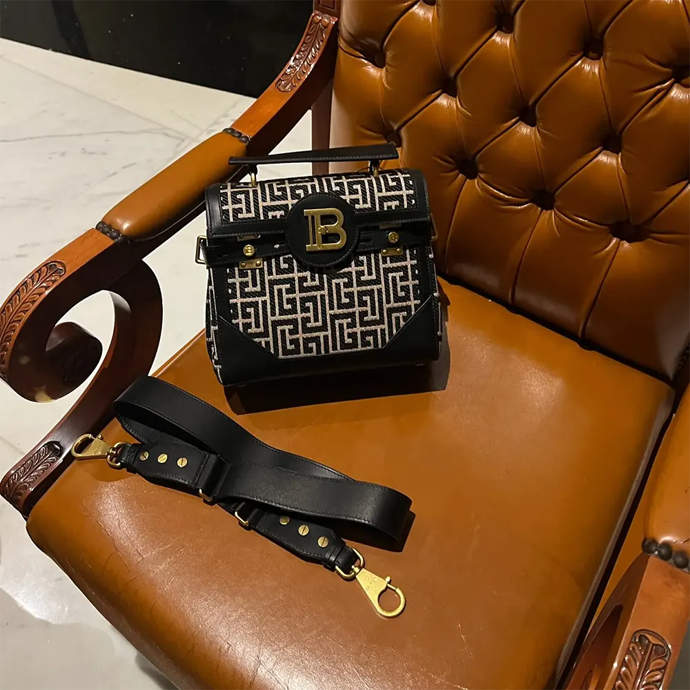 Side profile showing jacquard texture and leather detail on B-Buzz Bag