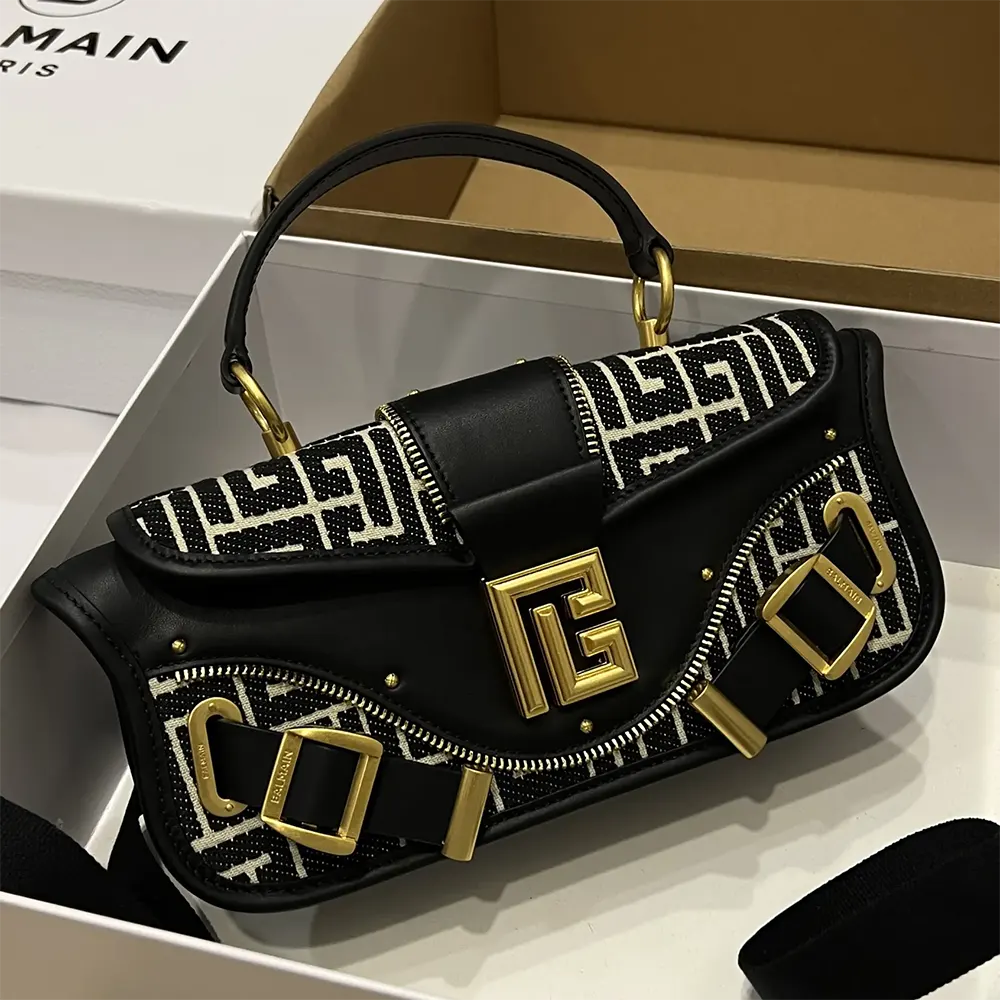 Close-up of Balmain jacquard monogram on leather clutch bag