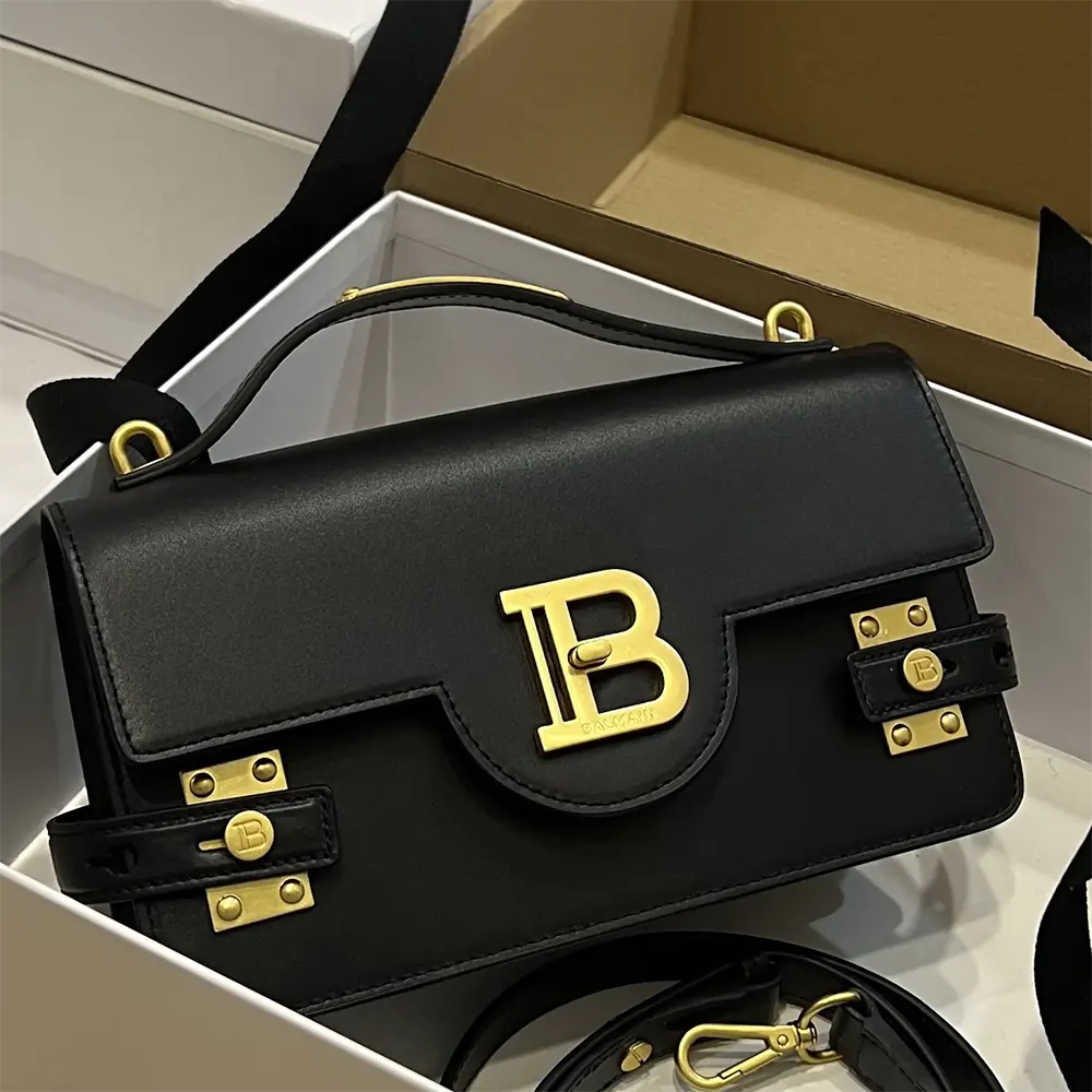 Close-up of Balmain Women Smooth Leather B-Buzz 24 Bag-Black flap and clasp details