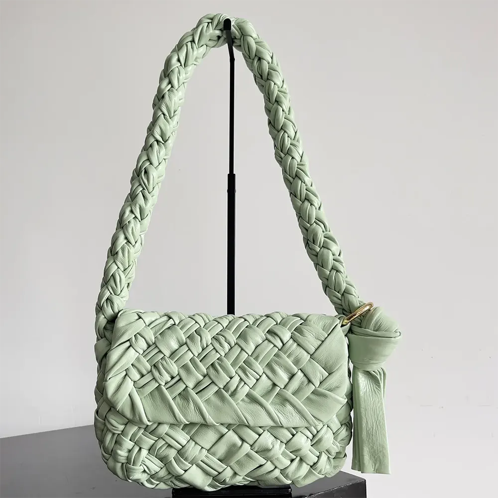 Close-up of intrecciato weave and gold hardware on Kalimero Città bag