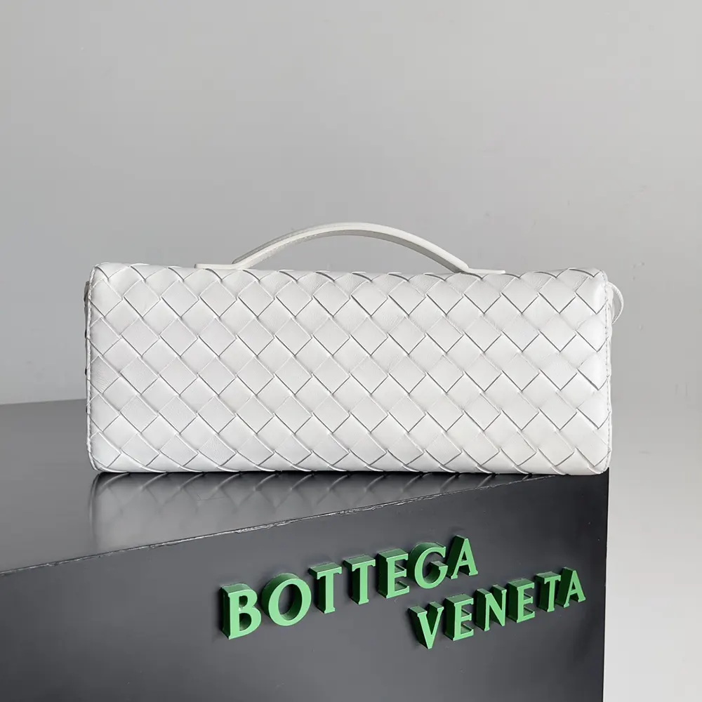 Side angle showing handle and slim profile of the Bottega Veneta clutch